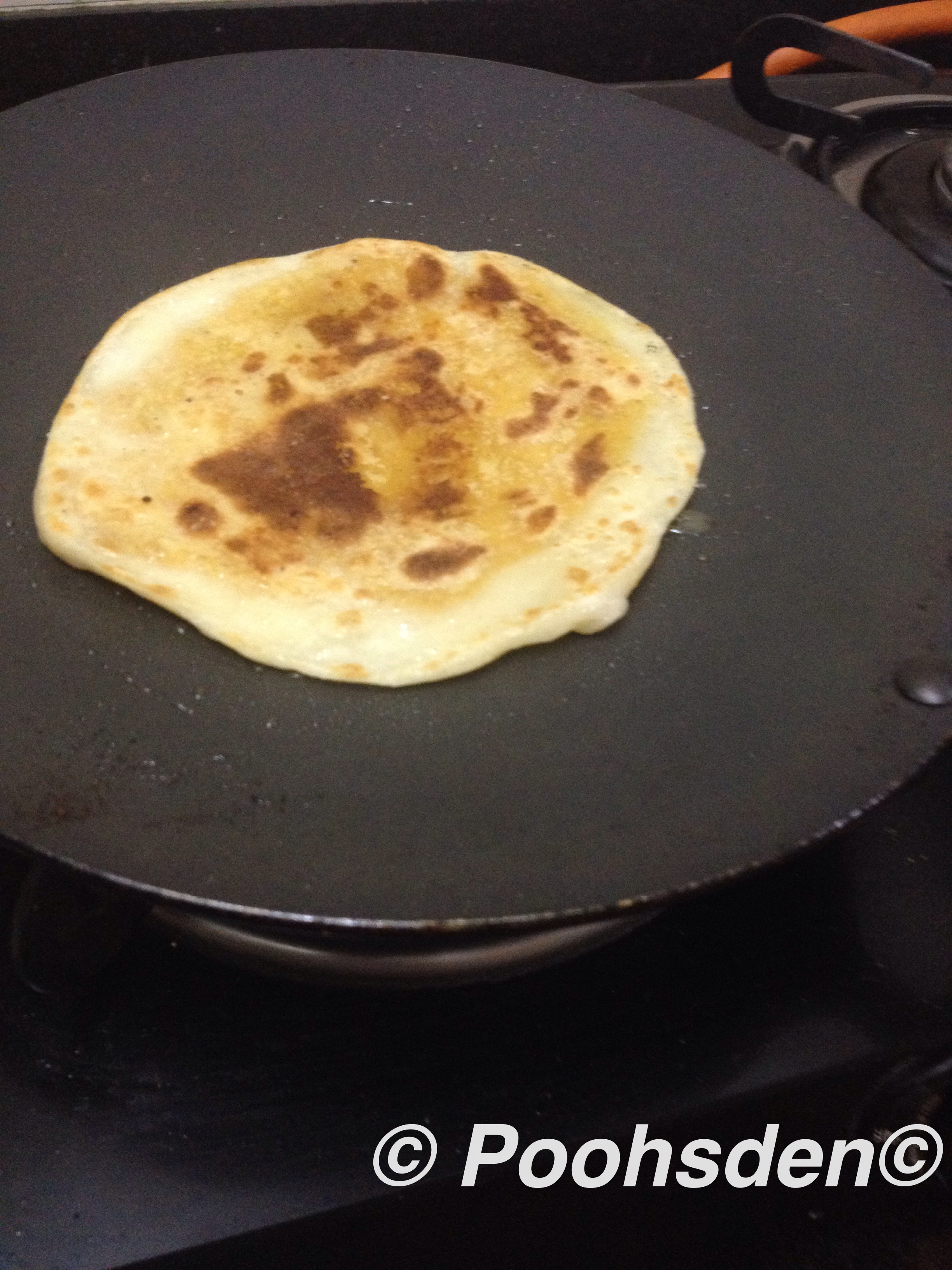 The bholis getting cooked on the tawa 