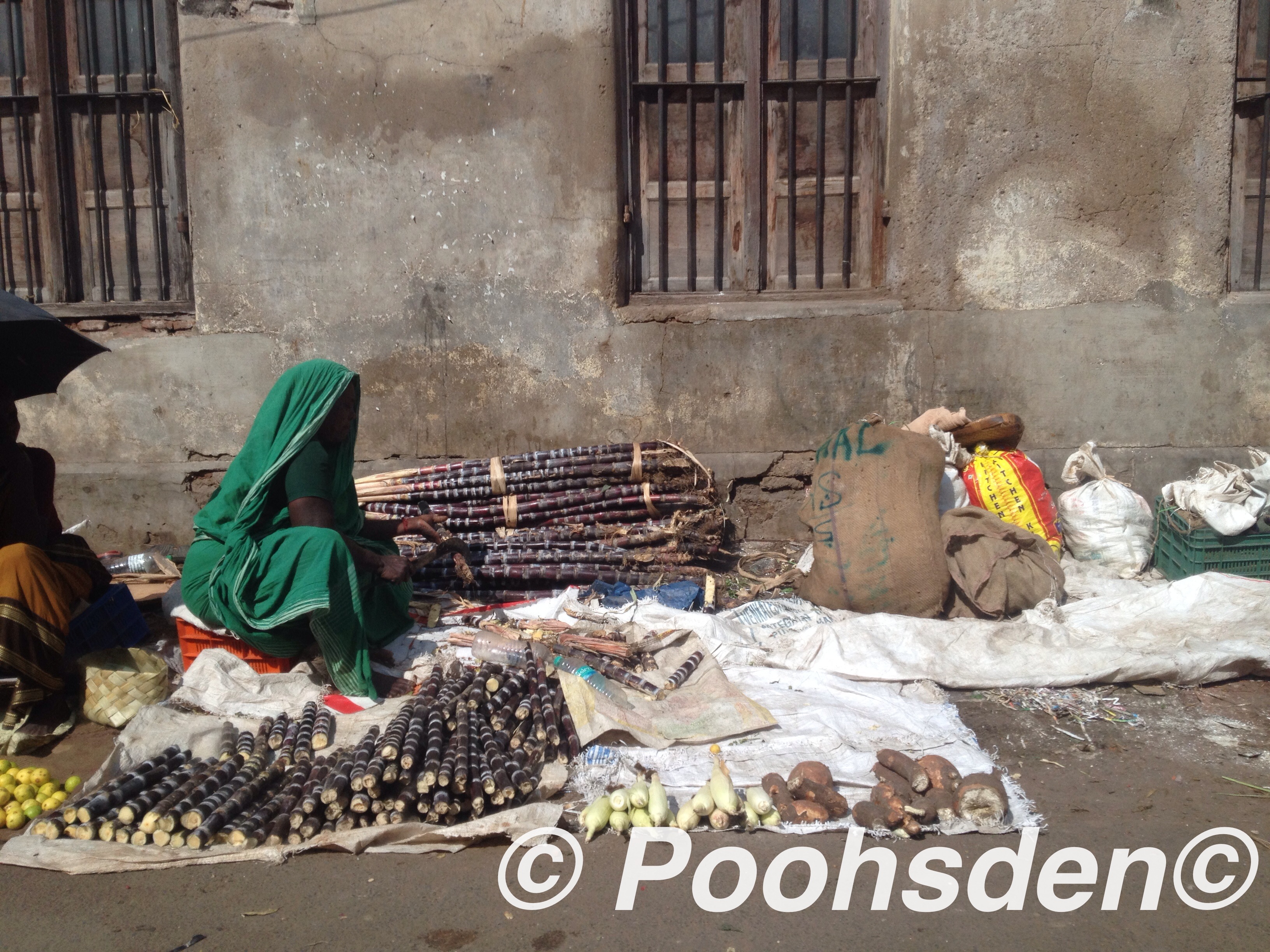 The lady in green - street vendor selling sugar cane in Madurai