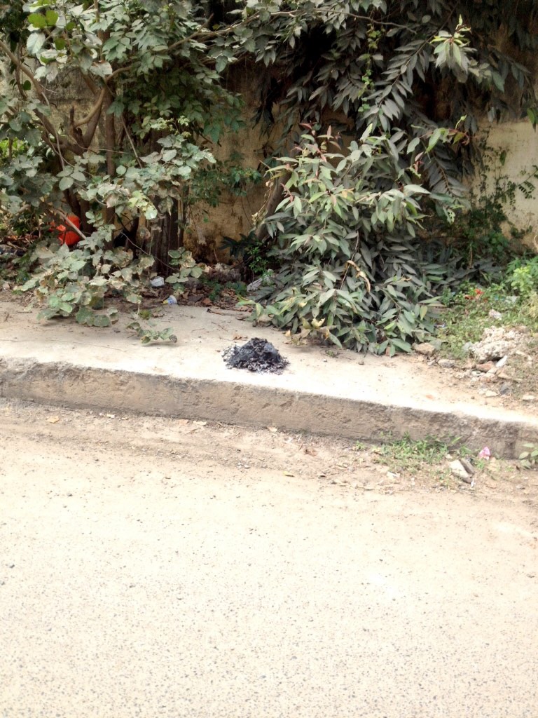 A symbolic pile of ash - burnt, polluted mass left in the corner